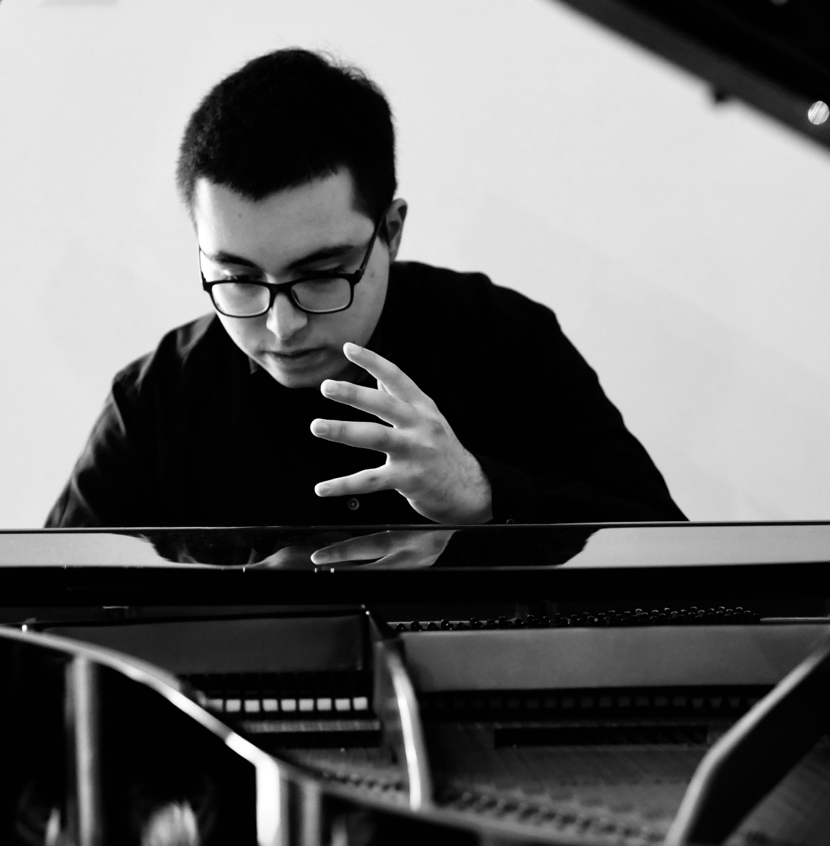 Lefteris Gavalas at the keyboard, one hand raised above the keys